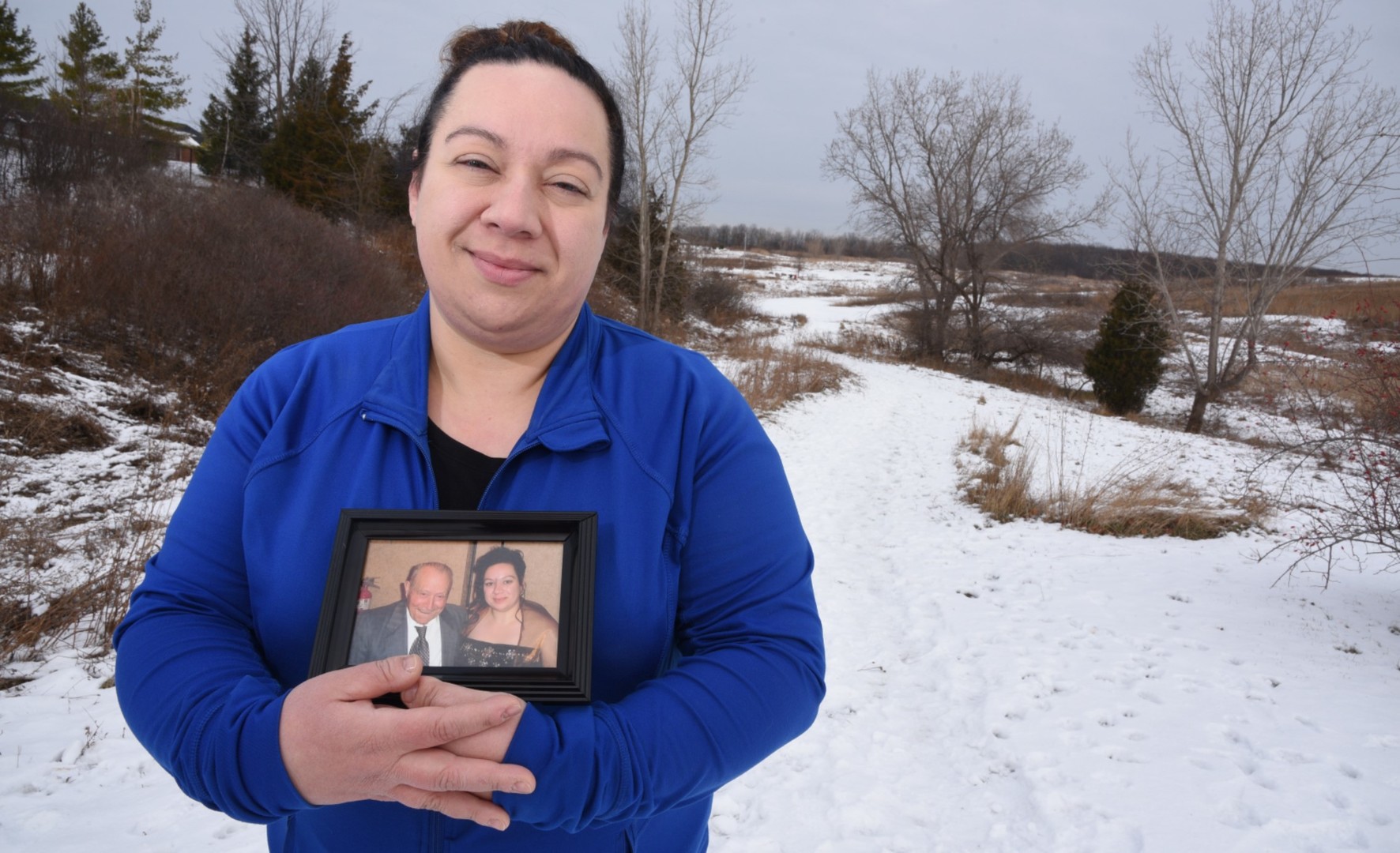 Gina Sforza holds a photograph of her grandfather.