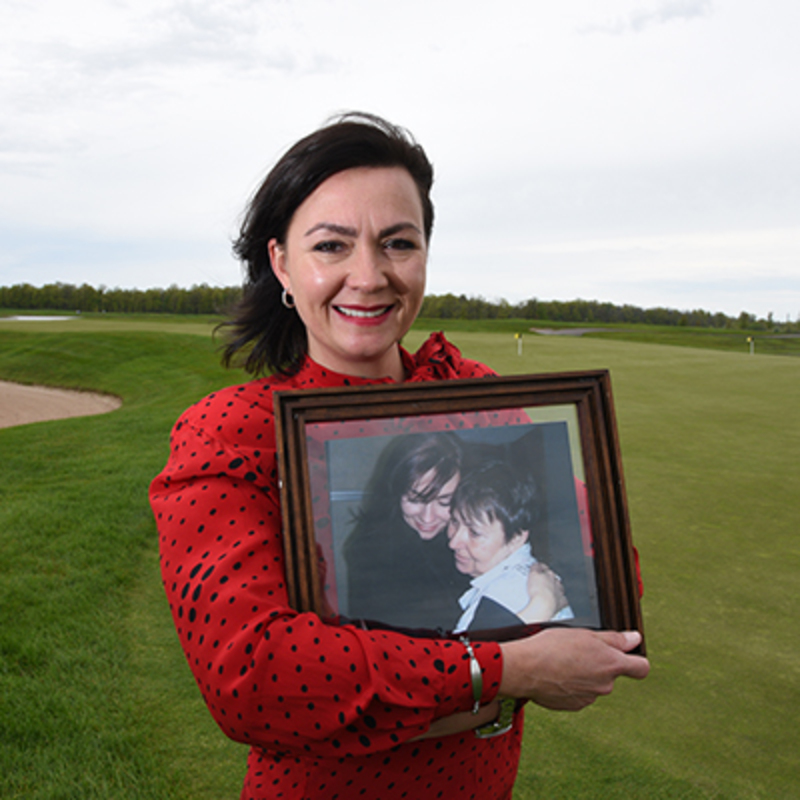 Amy holds a picture of her mom