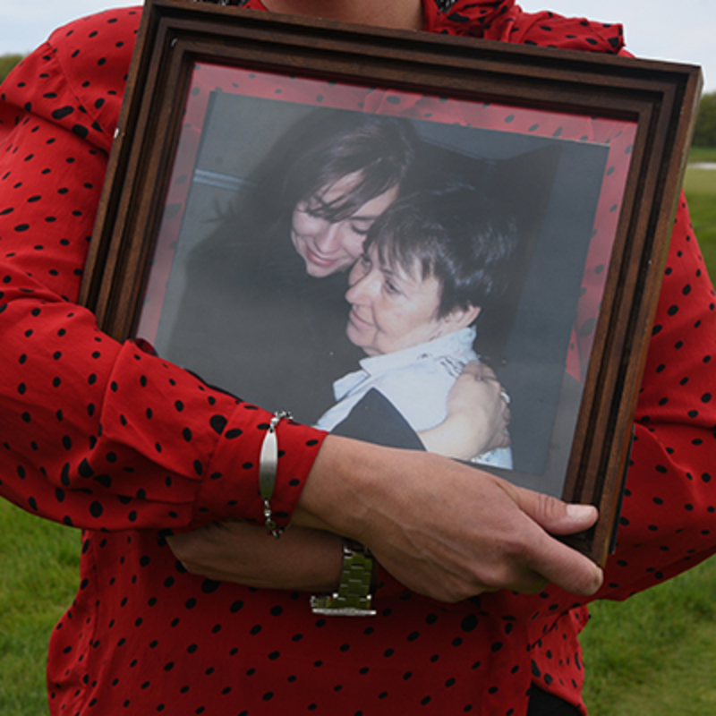 Amy holds a picture of her mom close up